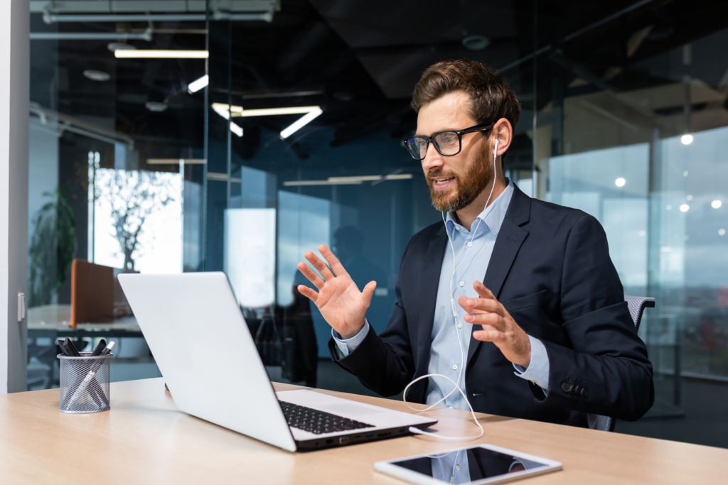 Corporate man wearing headset having animated virtual business call on computer