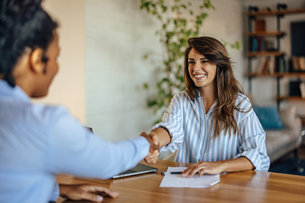 Two satisfied coworkers, reaching an agreement, at home office