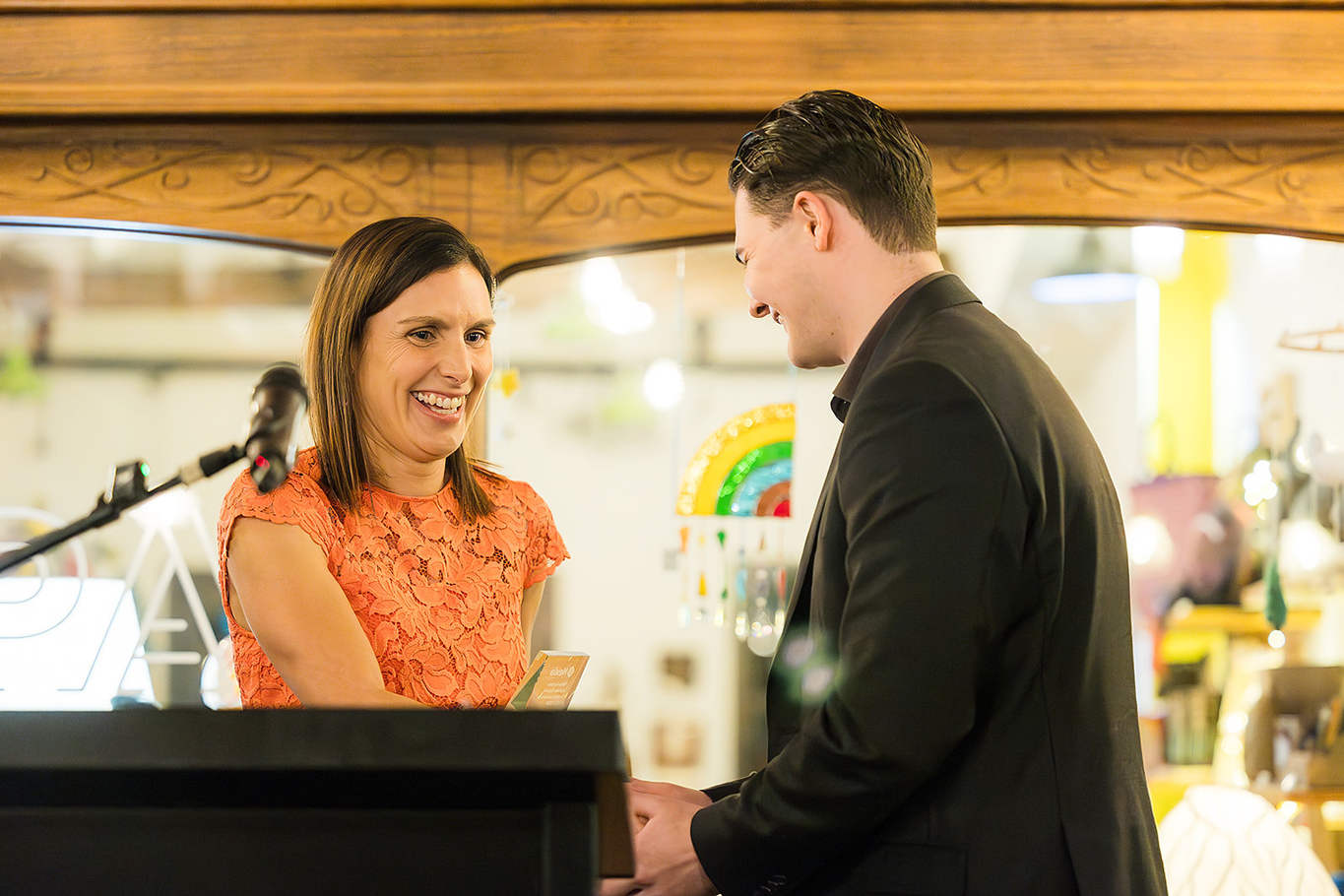 Young male Nexia employee receiving an award from female CEO